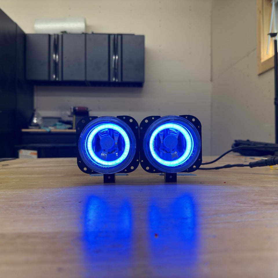 Two blue LED lights on a wooden surface with a blurred background